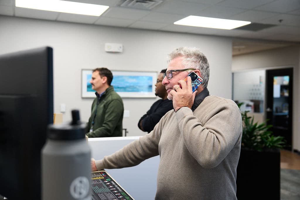 New Nexus Group team member on a phone call in the office, illustrating Activate In-Store buyer sell-in work