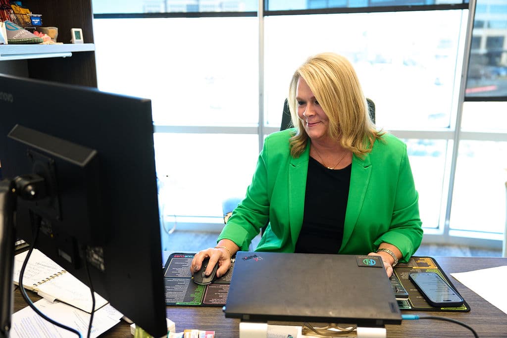 New Nexus Group team member working at her desk, illustrating the Activate In-Store retail readiness assessment