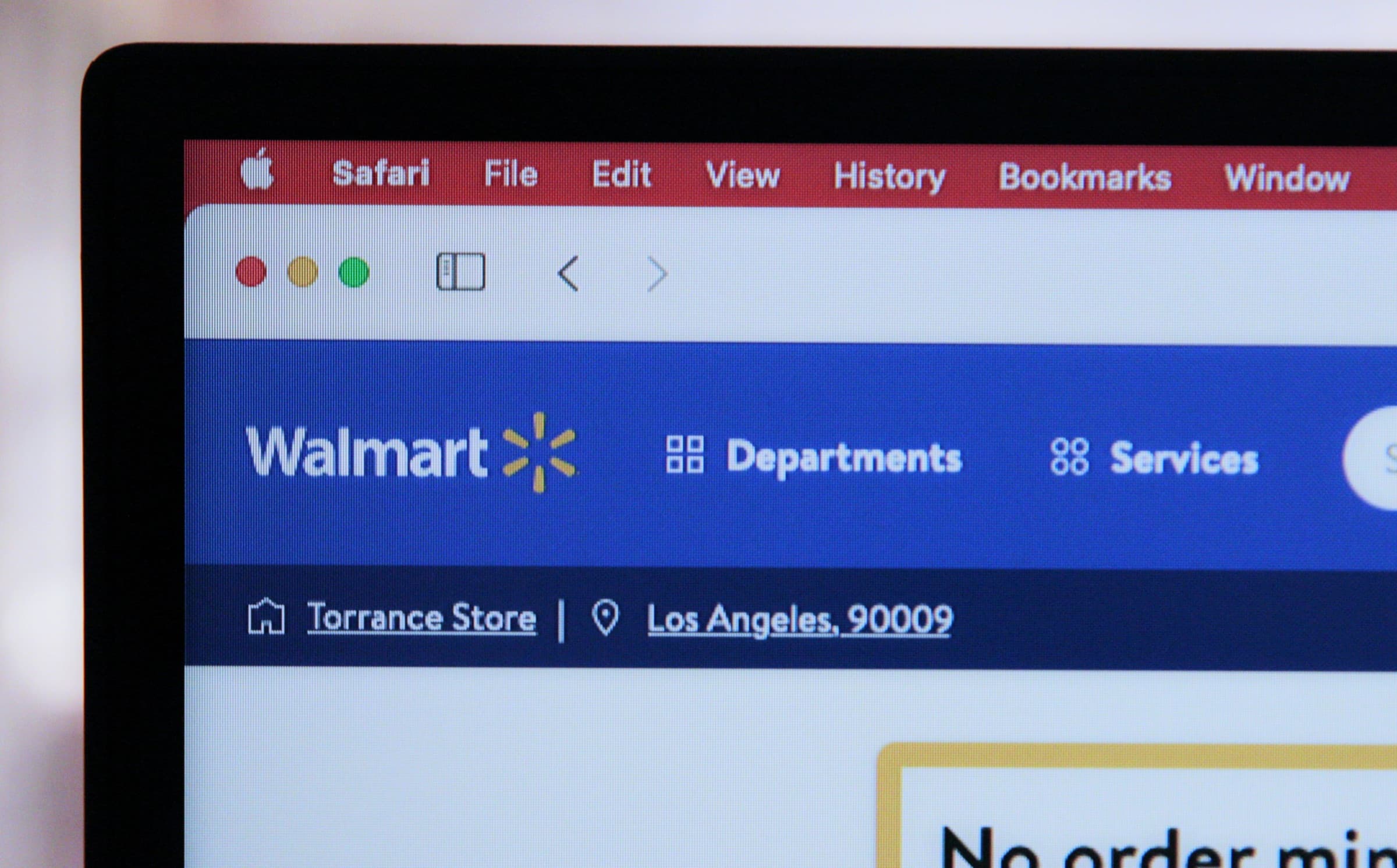 Walmart.com storefront on a laptop screen, illustrating New Nexus Group's Grow Retail digital shelf optimization
